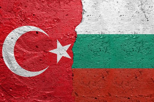 Turkey and Bulgaria - Cracked concrete wall painted with a Turkish flag on the left and a Bulgarian flag on the right