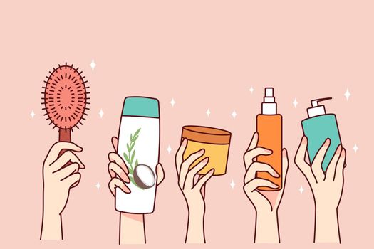 Hands holding diverse cosmetic bottle