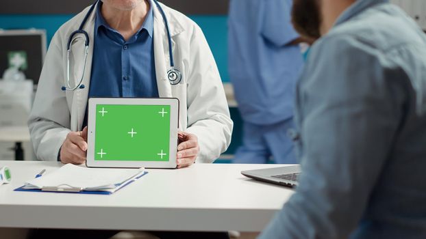 Health specialist showing horizontal greenscreen on tablet