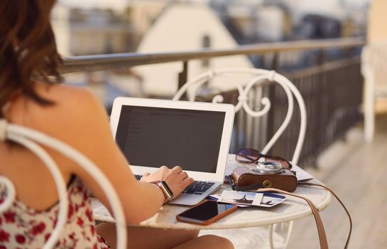Travel blog woman hotel paris working on vacation laptop communication on social media camera polaroid