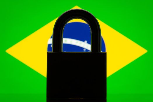 Silhouette of lock and flag of Brazil in the background