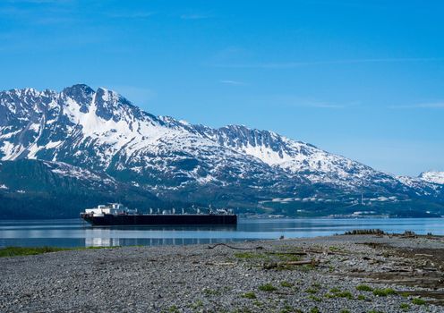 Natural gas tanker by the old town of Valdez in Alaska