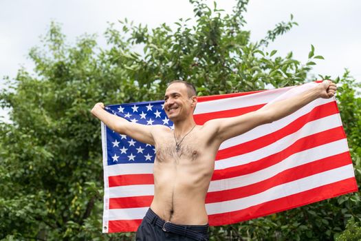Naked handsome vogue man with american flag