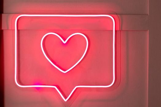 Bright luminous digital neon sign for a store or card beautiful shiny with a love heart.