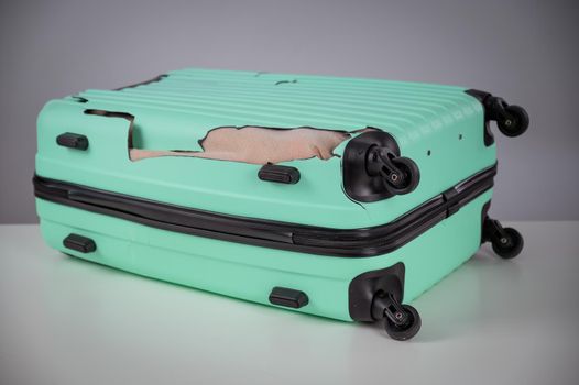 Mint damaged suitcase on a white background.