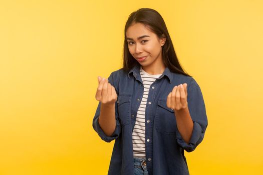 Portrait of young asian woman on yellow background.