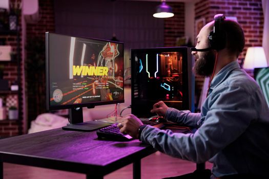 Young person winning action video games on computer
