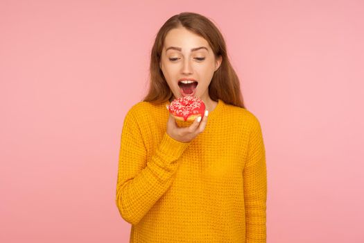 Portrait of young emotional woman on pink background.