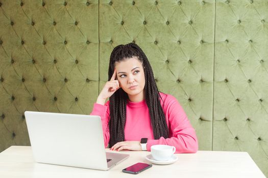 Emotional woman in pink shirt working in office.
