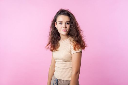 Emotional teenager girl on pink background.