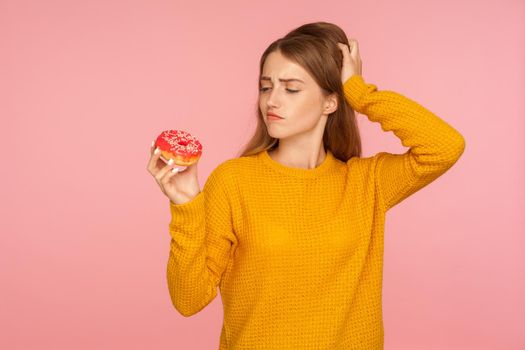 Portrait of young emotional woman on pink background.