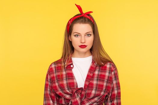 Young beautiful woman standing on yellow background.