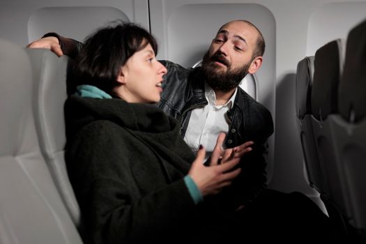 Jet passengers having conversation on commercial flight