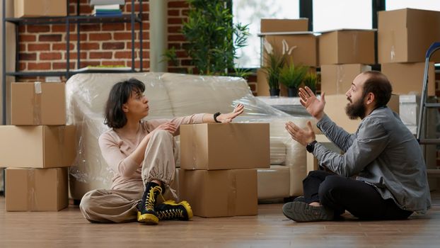 Man and woman disapproving with each other after home relocation