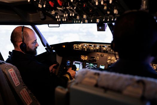 Plane pilot pushing buttons to start power on dashboard control
