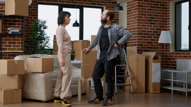 Homeowners moving in new apartment with boxes and sharing a kiss