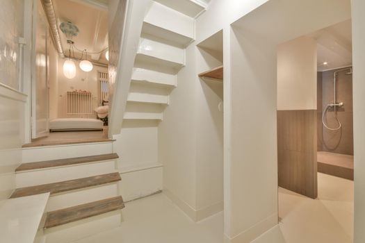 Spacious bright corridor with stairs and entrance to the bedroom