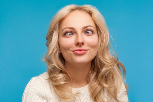 Portrait of blonde woman on blue background.