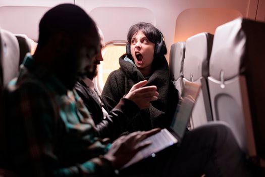 Multiethnic group of people flying abroad in economy class