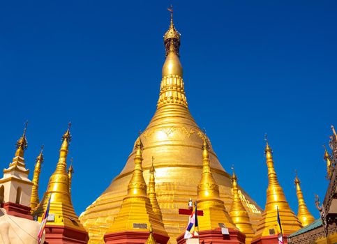 A group of golden pagodas under the blue sky of Myanmar