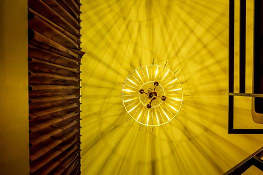 Warm colored light from a modern ceiling pendant lamp