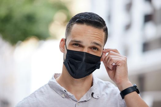 A man wearing a protective face mask while out in the city. A man wearing a protective face mask while out in the city.
