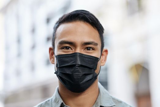 Man wearing a face mask while out in the city. Man wearing a face mask while out in the city.