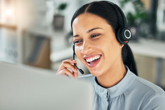 Female customer service representative using headset and consulting clients online. Call center concept. Smiling young woman with headset doing video call and working from home. Helpdesk and hotline.