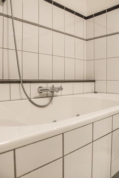Shower tap in tiled bathroom