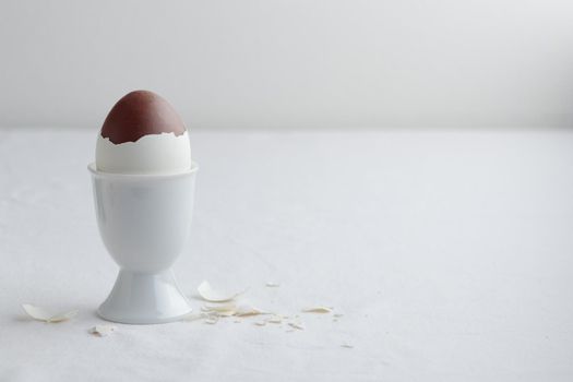 Chocolate egg on white eggstand holder