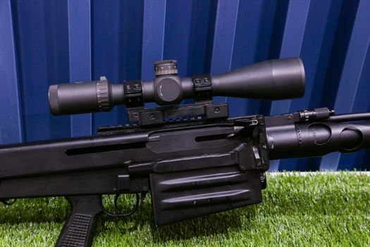 Sniper rifle with telescopic sight close-up.