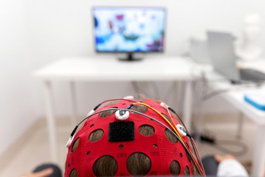 Headgear of a girl monitoring the impulse signals during a biofeedback session