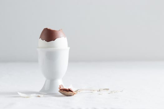 Chocolate egg on white eggstand holder