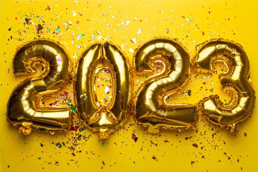 2023 Happy New Year concept from golden foil balloon