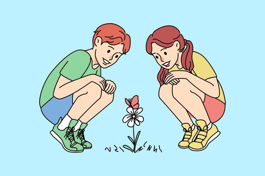 Smiling kids looking at flowers