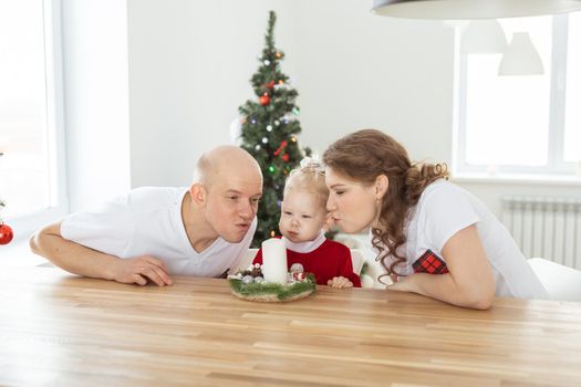 Baby child with hearing aid and cochlear implant having fun with parents in christmas room. Deaf , diversity and health concept