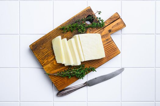 Cyprus Halloumi cheese set, on white ceramic squared tile table background, top view flat lay, with copy space for text