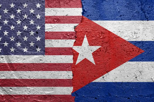 United States of America and Cuba - Cracked concrete wall painted with a USA flag on the left and a Cuban flag on the right stock photo