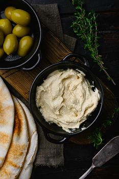 Healthy Homemade Creamy Hummus set, on old dark wooden table background, top view flat lay