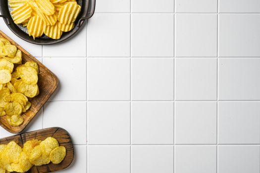 Honey BBQ Flavored Potato Chips on white ceramic squared tile table background, top view flat lay, with copy space for text