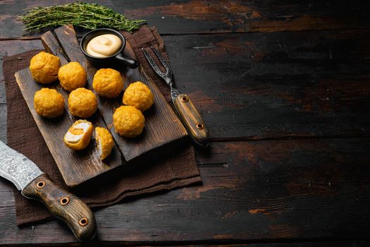 Battered meatballs on old dark wooden table background, with copy space for text