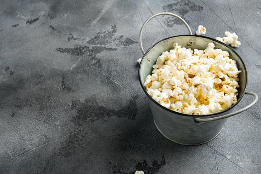 Salted popcorn on gray stone table background, with copy space for text
