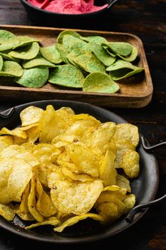 Limon Flavored Potato Chips on old dark wooden table background