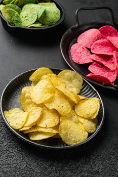 Classic Potato Chips on black dark stone table background