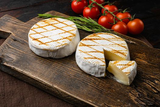 Oven Backed camembert on old dark wooden table background