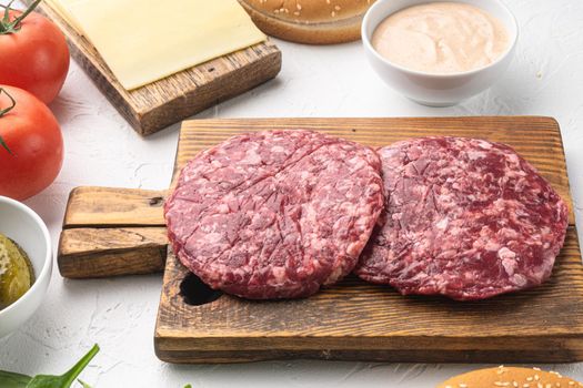 Raw Minced Steak Burgers from Beef Meat, on white stone background