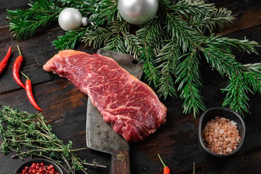Raw Striploin marbled beef steak for the new year, on old dark wooden table background