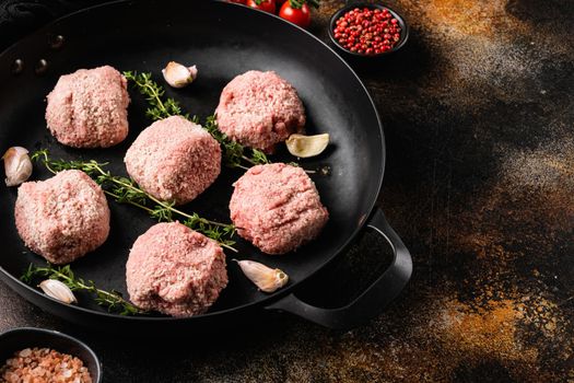 Meatball patties from minced meat, on old dark rustic table background, with copy space for text