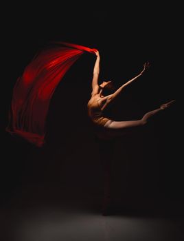 Shell hold more than your attention. Shot of a performer dancing against a dark background.