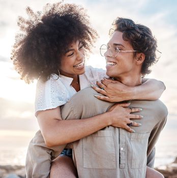 A young mixed race couple enjoying a day at the beach looking happy and in love. A young mixed race couple enjoying a day at the beach looking happy and in love.